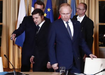 FILE - Russian President Vladimir Putin, right, and Ukrainian President Volodymyr Zelenskyy arrive for a working session at the Elysee Palace, Dec. 9, 2019, in Paris. (Ian Langsdon/Pool via AP, File)