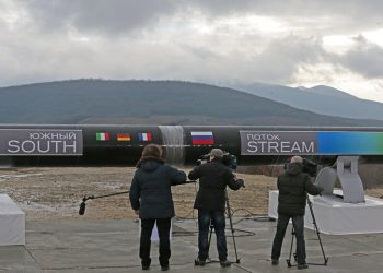Cameramen take pictures of the pipeline before the South Stream welding ceremony in Anapa, Russia, Friday, Dec. 7, 2012. Russian energy giant Gazprom on Friday launched the construction of the South Stream pipeline which is expected to be delivering up to 63 billion cu. meters of Russian gas to Europe annually starting 2015. (AP Photo/Mikhail Metzel)