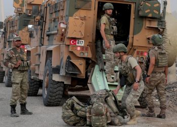 Turkish soldiers stand near military vehicles in the border town of Akcakale in Sanliurfa province, Turkey, October 11, 2019. REUTERS/Khalil Ashawi