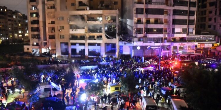 People gather at the site of a strike, reported by Lebanese media to be an Israeli strike targeting a Hamas office, in the southern suburb of Beirut on January 2, 2024. Hamas deputy leader Aruri was killed in an Israeli strike on Beirut's southern suburbs, on January 2, 2024, two security officials told AFP, with state media reporting the strike hit a Hamas office. (Photo by AFP)