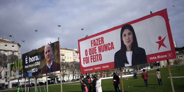 Birds fly above election campaign billboards for leftist parties in Lisbon, Portugal, Saturday, Feb. 24, 2024. The official two-week campaign period before Portugal's snap general election begins Feb. 25, with the country's two moderate mainstream parties once again expected to collect most votes but with the possible rise of a populist party potentially adding momentum to Europe's drift to the right. (AP Photo/Armando Franca)