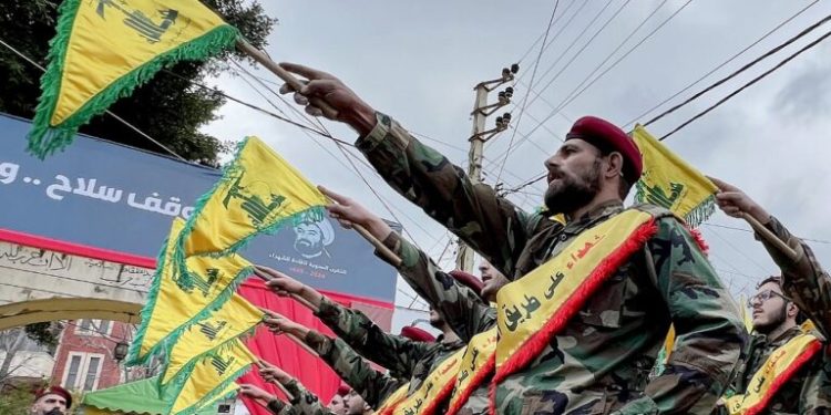 Fighters of the Lebanese Shiite group Hezbollah parade during a ceremony to commemorate the party's fallen leaders in the Lebanese village of Jibshit, about 50 kilometres south of the capital Beirut on February 15, 2024. (Photo by MAHMOUD ZAYYAT / AFP)