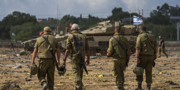 Israeli soldiers gather in a staging area near the border with Gaza Strip, in southern Israel, Thursday, Oct. 19, 2023. (AP Photo/Tsafrir Abayov)