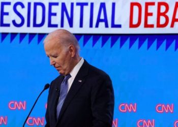 Democrat presidential candidate U.S. President Joe Biden listens as Republican presidential candidate and former U.S. President Donald Trump speaks during their debate in Atlanta, Georgia, U.S., June 27, 2024. REUTERS/Brian Snyder