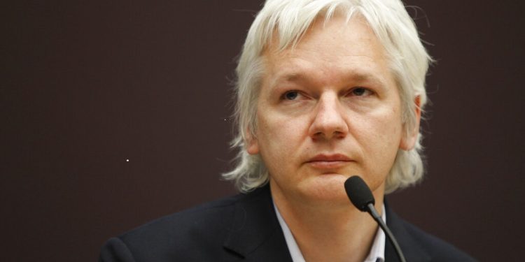 WikiLeaks founder Julian Assange listens during a news conference in central London, Thursday, Dec. 1, 2011. The whistle-blowing website has released details of companies it says are selling information obtained by monitoring people's mobile phones and computers. According to Assange, more than 150 organizations around the world have the ability to use phones as tracking devices as well as intercept messages and listen to calls. (AP Photo/Lefteris Pitarakis)