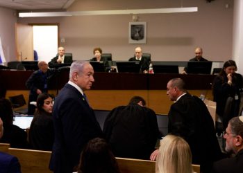 Israeli Prime Minister Benjamin Netanyahu enters the district court in Tel Aviv at the start of his hearing on corruption charges on December 10, 2024. Netanyahu, the first sitting prime minister of Israel to face a criminal trial, testified for the first time when his corruption case resumed on December 10 on charges of bribery, fraud and breach of public trust in three separate cases. (Photo by Menahem Kahana / POOL / AFP)