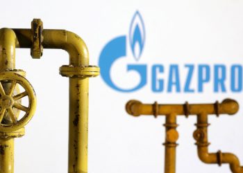 Model of natural gas pipeline and Gazprom logo, July 18, 2022. REUTERS/Dado Ruvic/Illustration