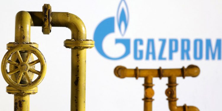 Model of natural gas pipeline and Gazprom logo, July 18, 2022. REUTERS/Dado Ruvic/Illustration