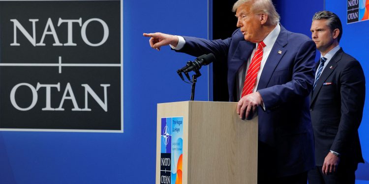 U.S. President Donald Trump speaks at a press conference, as Secretary of Defense Pete Hegseth stands, at the NATO summit in The Hague, Netherlands, June 25, 2025. REUTERS/Brian Snyder